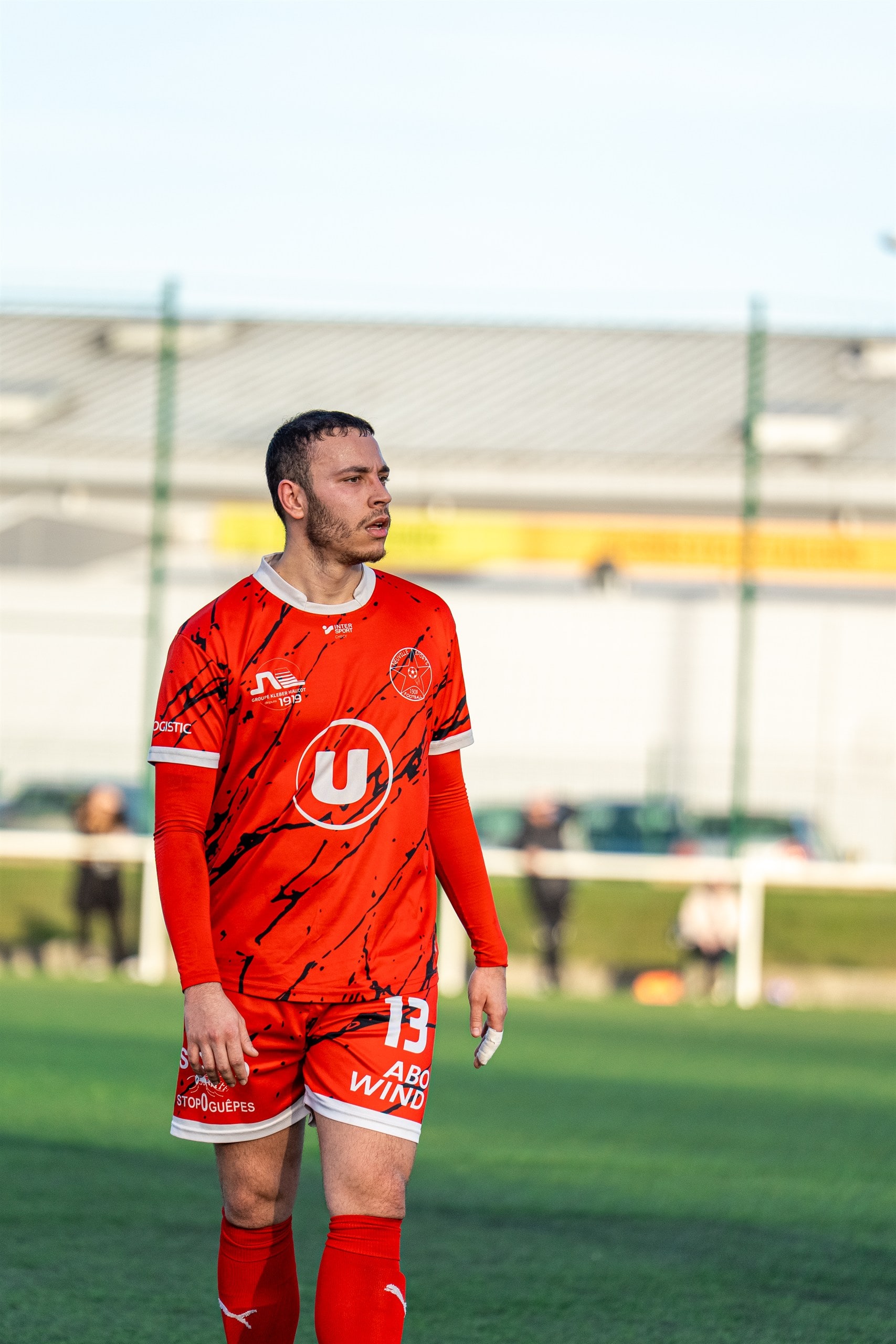 Attaquant en maillot rouge, coup d'œil vers le but